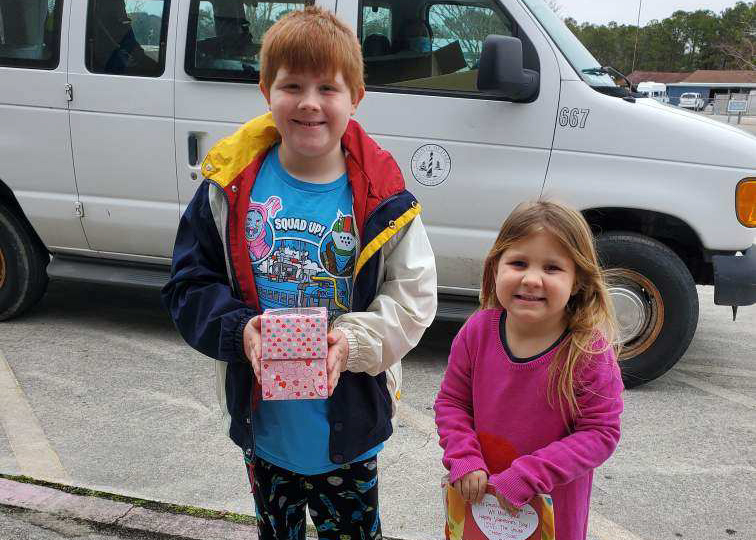 Children receive valentines delivered to them when the youth center facility is closed.