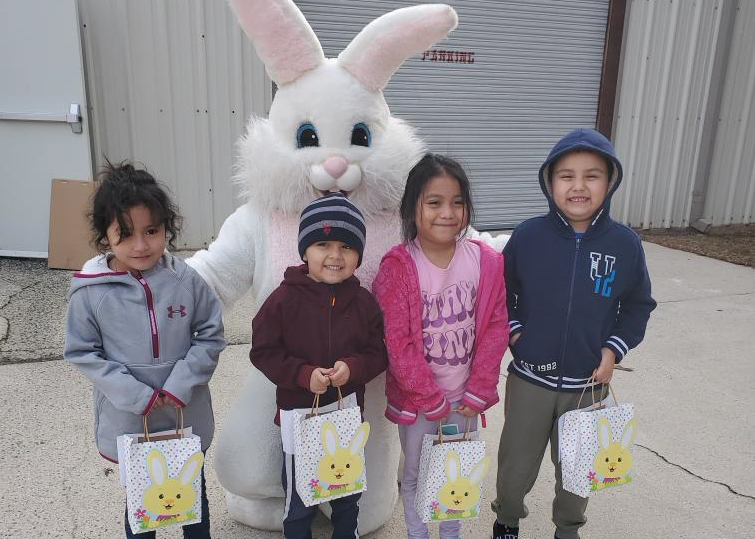 Children visit the Easter bunny at the Youth Center and pick up bags of Easter eggs.