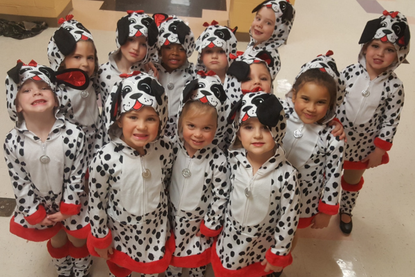 Image of a group of children dressed in Dalmatian outfits in the Dare County Dance program.