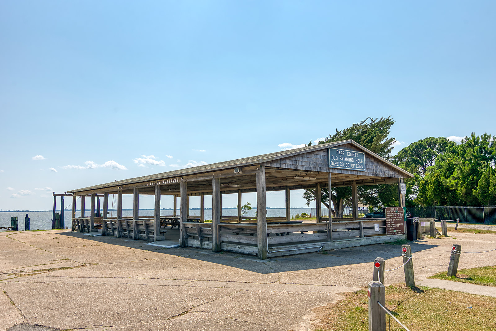 Image of a shelter with a sign that reads, "Dare County Swimming Hole"