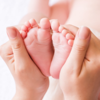 Image of a woman holding a baby's feet in her hands.