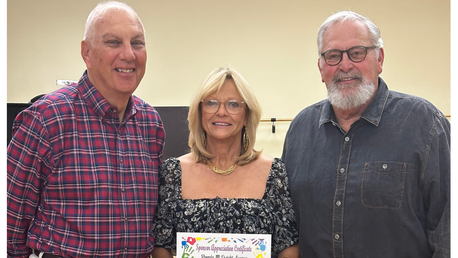 Mr. Tim, Ms. Rhonda and Mr. Dwight standing together holding a certificate.