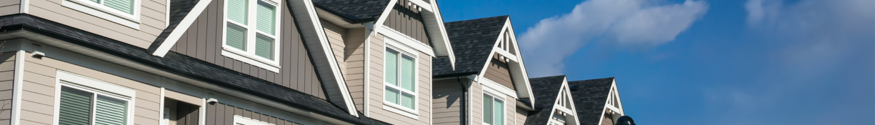 Narrow image of the roofs of an apartment building.