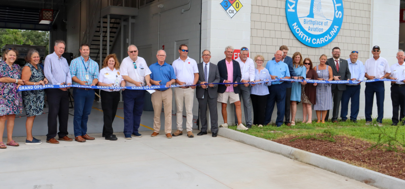 Image of local officials cutting the ribbon during the EMS Station 1 Ribbon Cutting Ceremony.