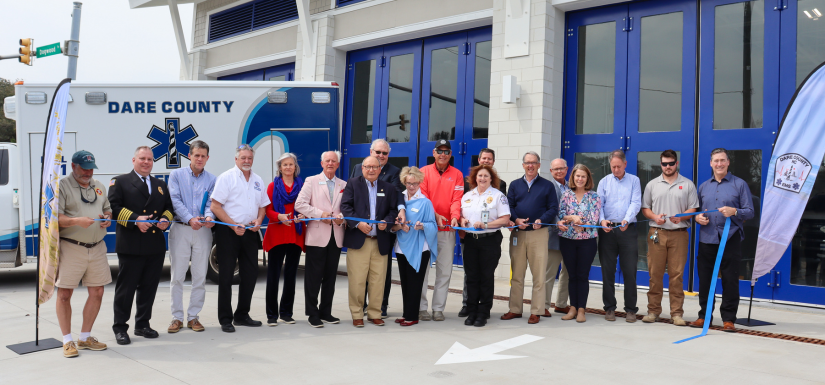 Image of local officials cutting the ribbon during the EMS Station 4 Ribbon Cutting Ceremony.