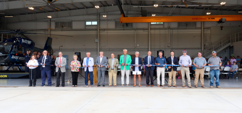 Image of local officials cutting the ribbon during the EMS Station 7 Ribbon Cutting Ceremony.