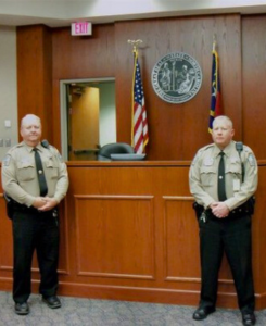 Image of two Dare County Sheriff's Office deputies standing in a court room.